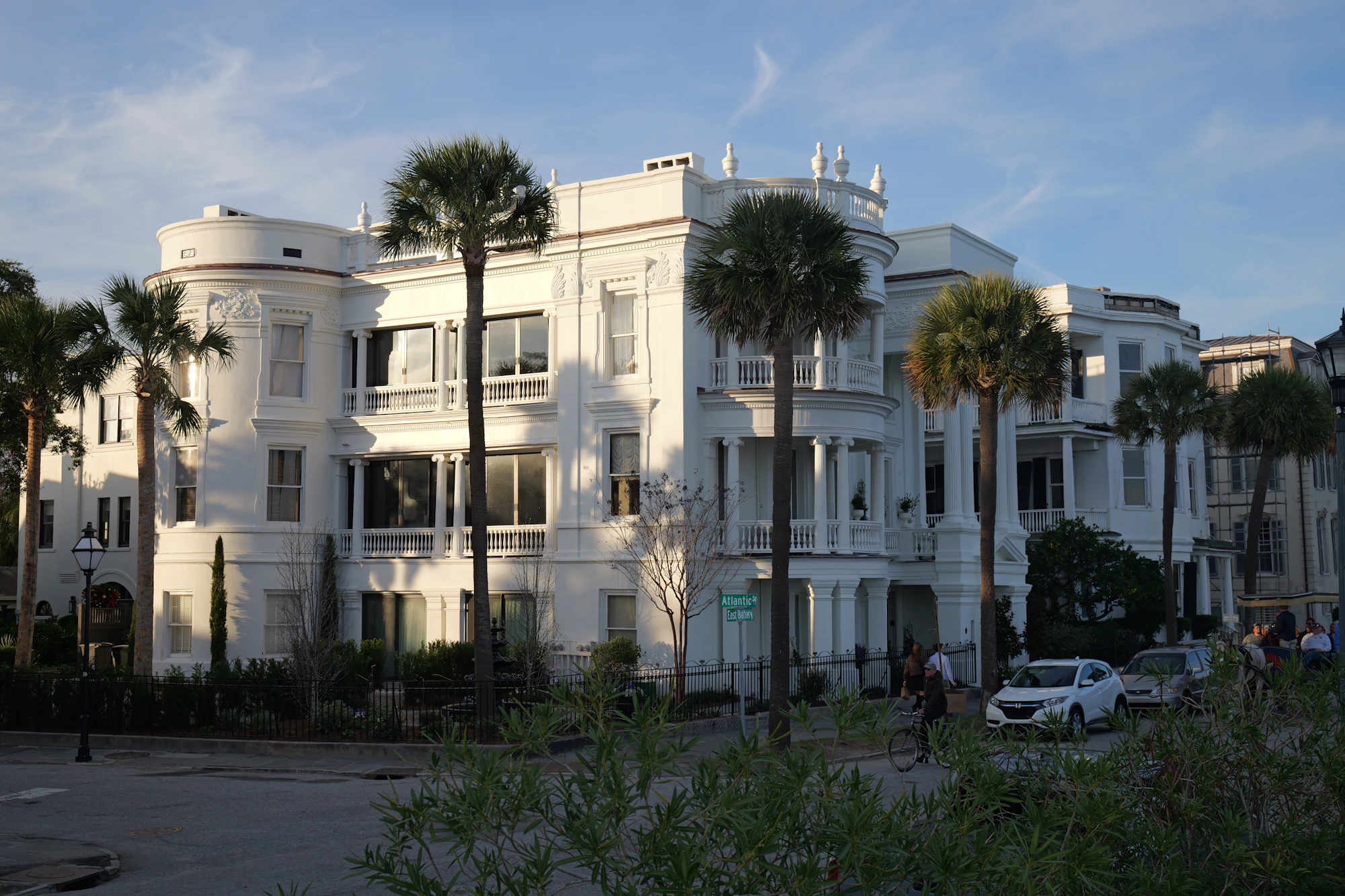 Grand white Charleston home with palm trees in front