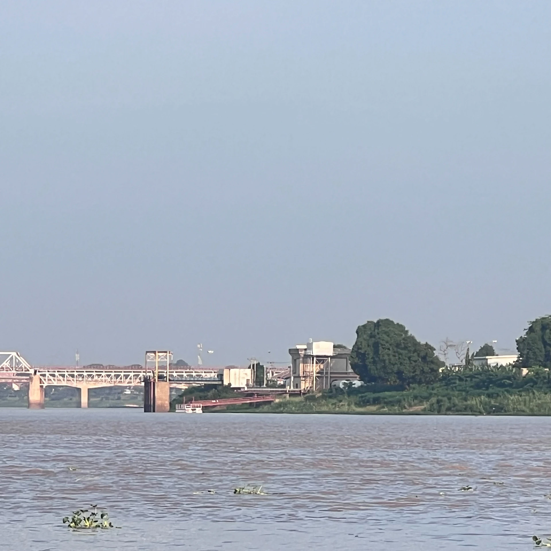 A large body of water with a bridge in the background