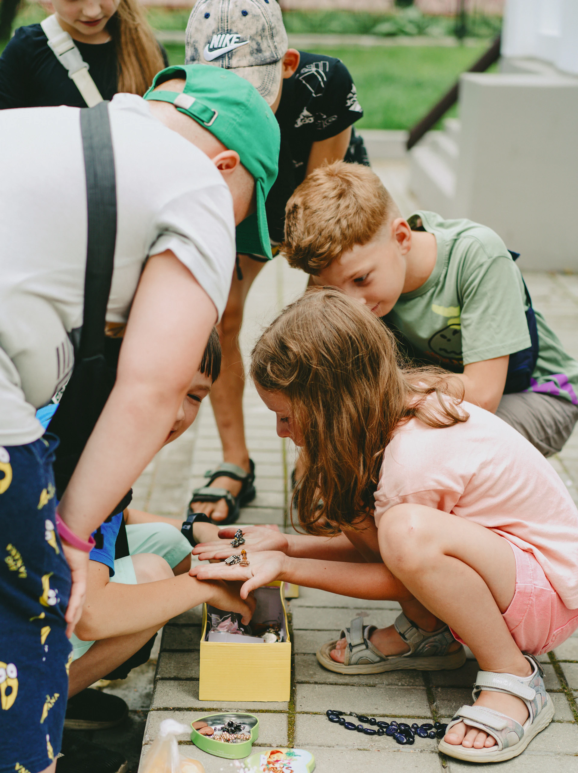 A group of children sitting on the ground playing a game