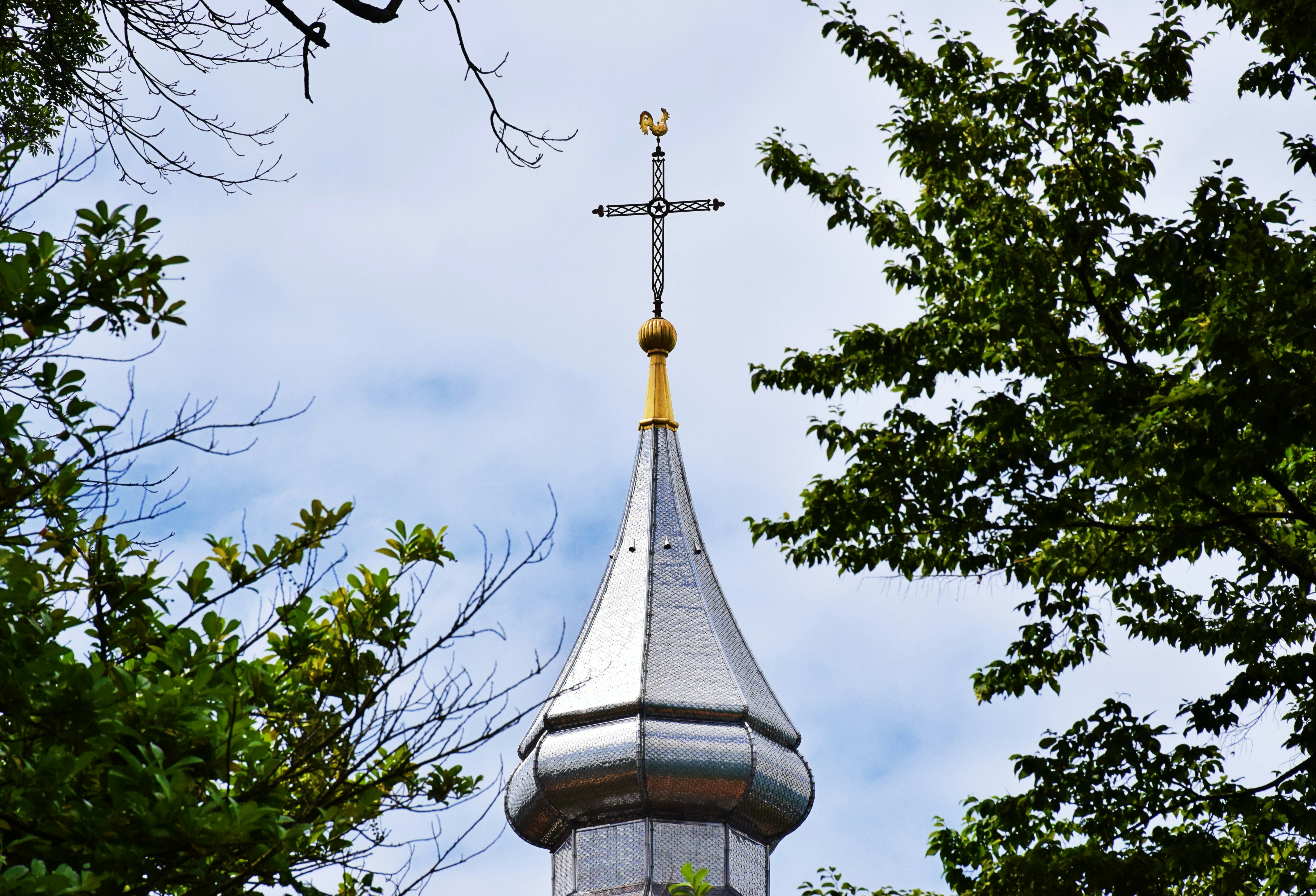 A church steeple with a cross on top, 