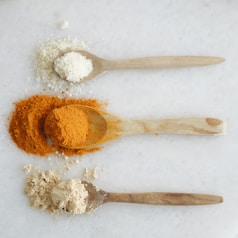 Three spoons with different types of spices on them