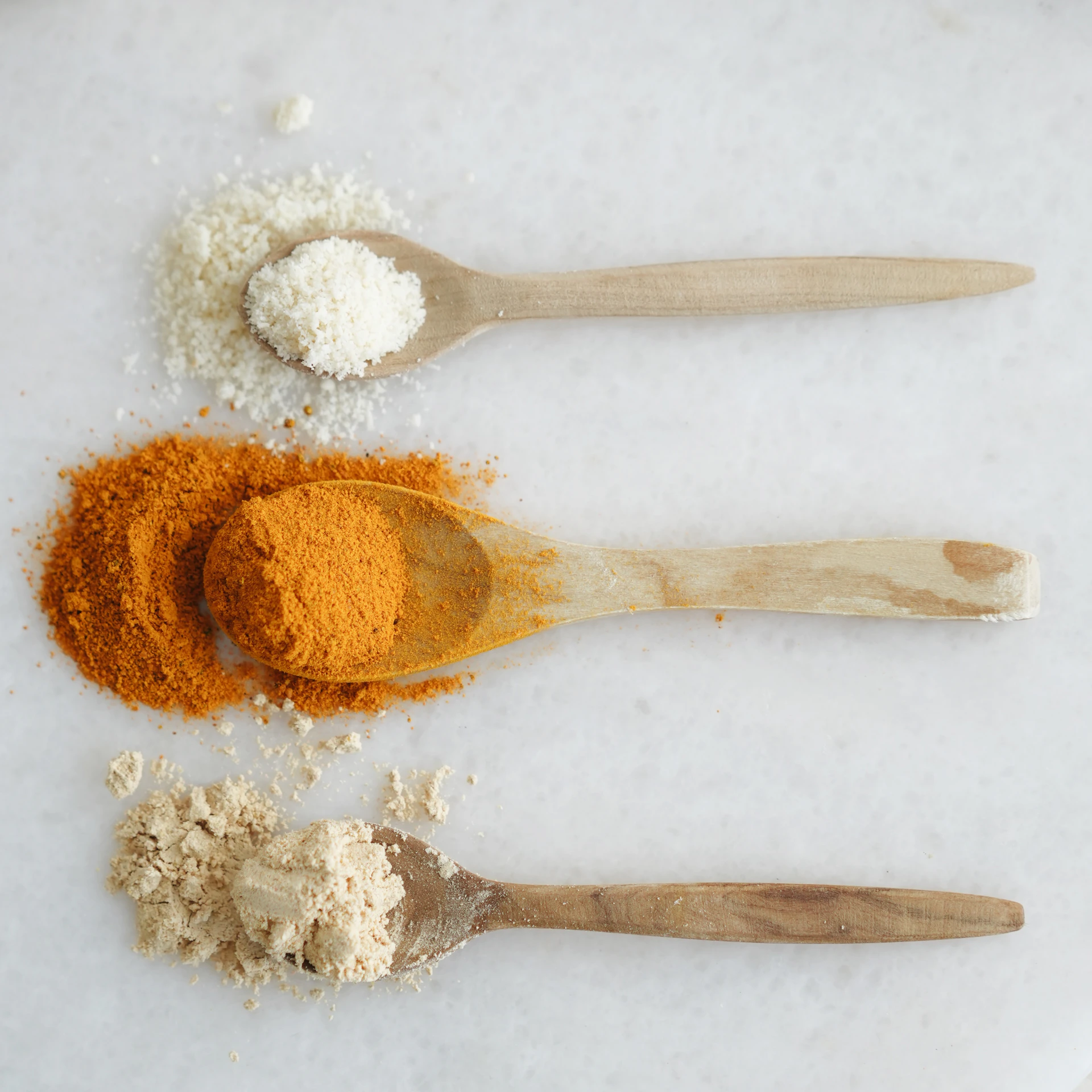 Three spoons with different types of spices on them