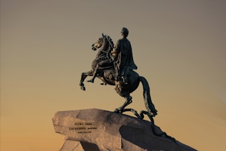 A statue of a man riding on the back of a horse