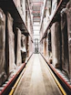 A train track in a large building with statues on it