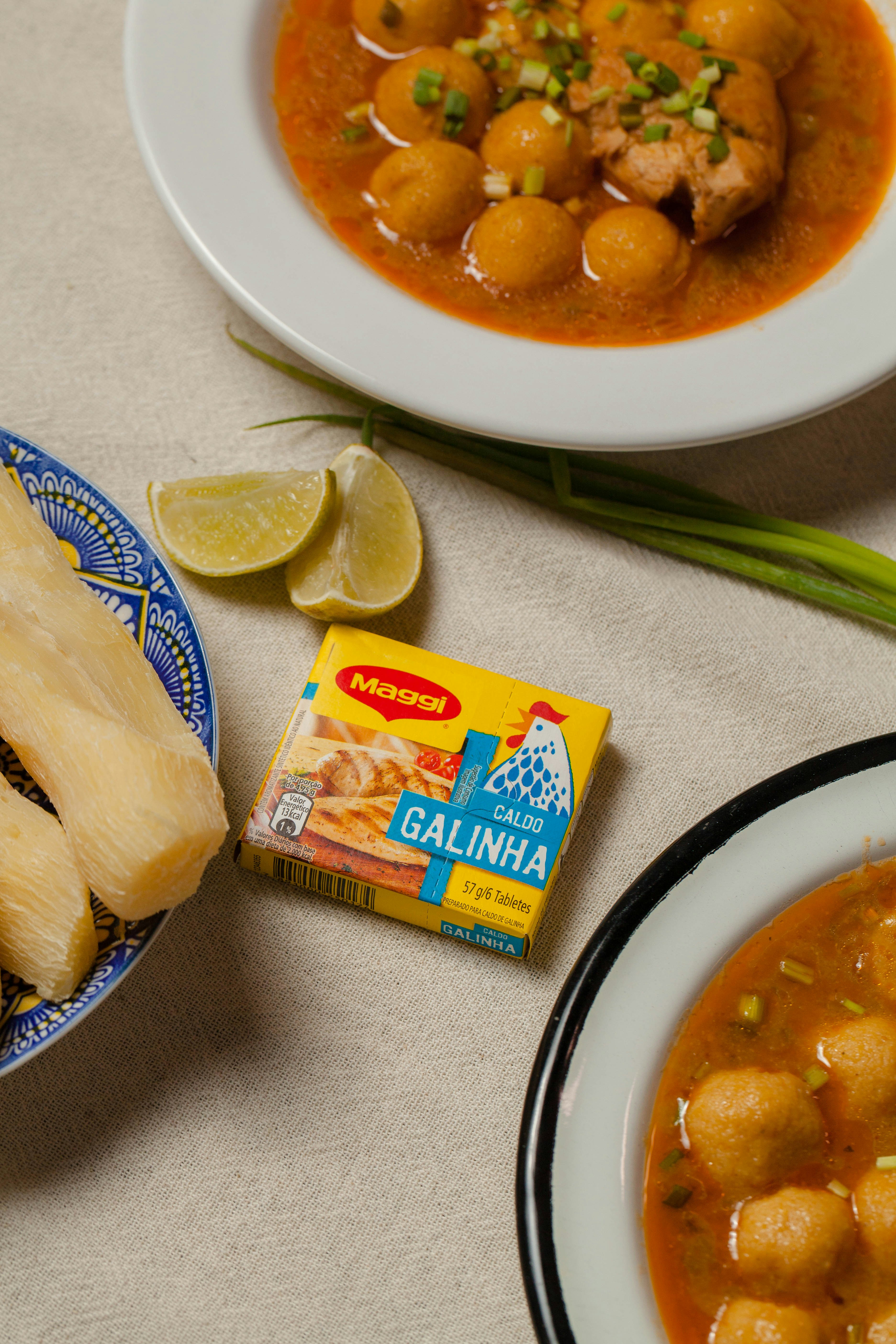 A table topped with plates of food and bowls of soup
