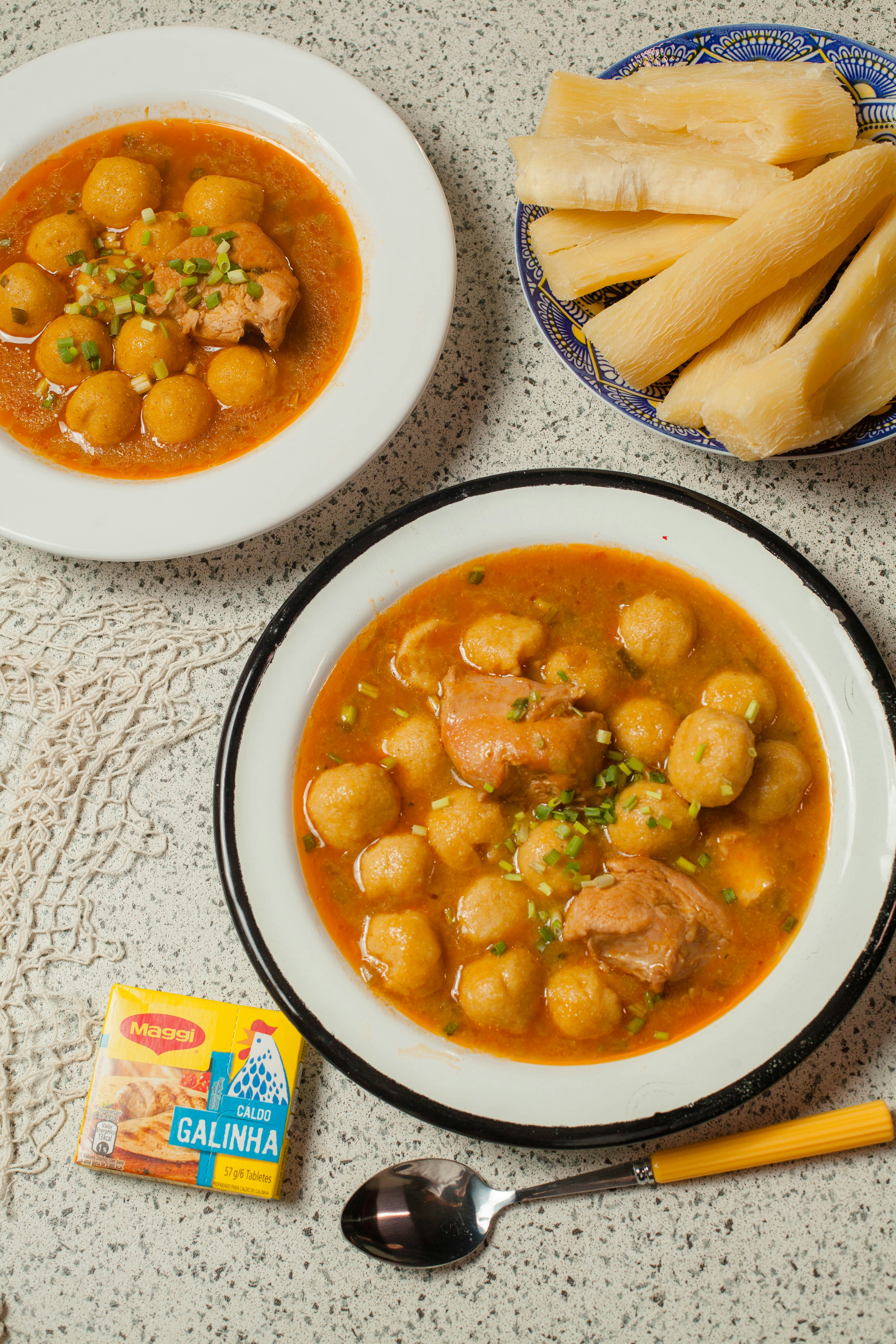 A table topped with bowls of food and a bowl of soup