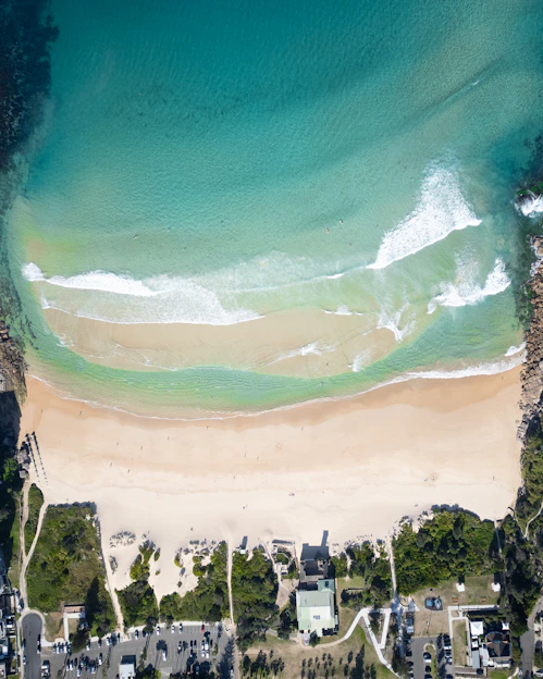 An aerial view of a sandy beach and ocean