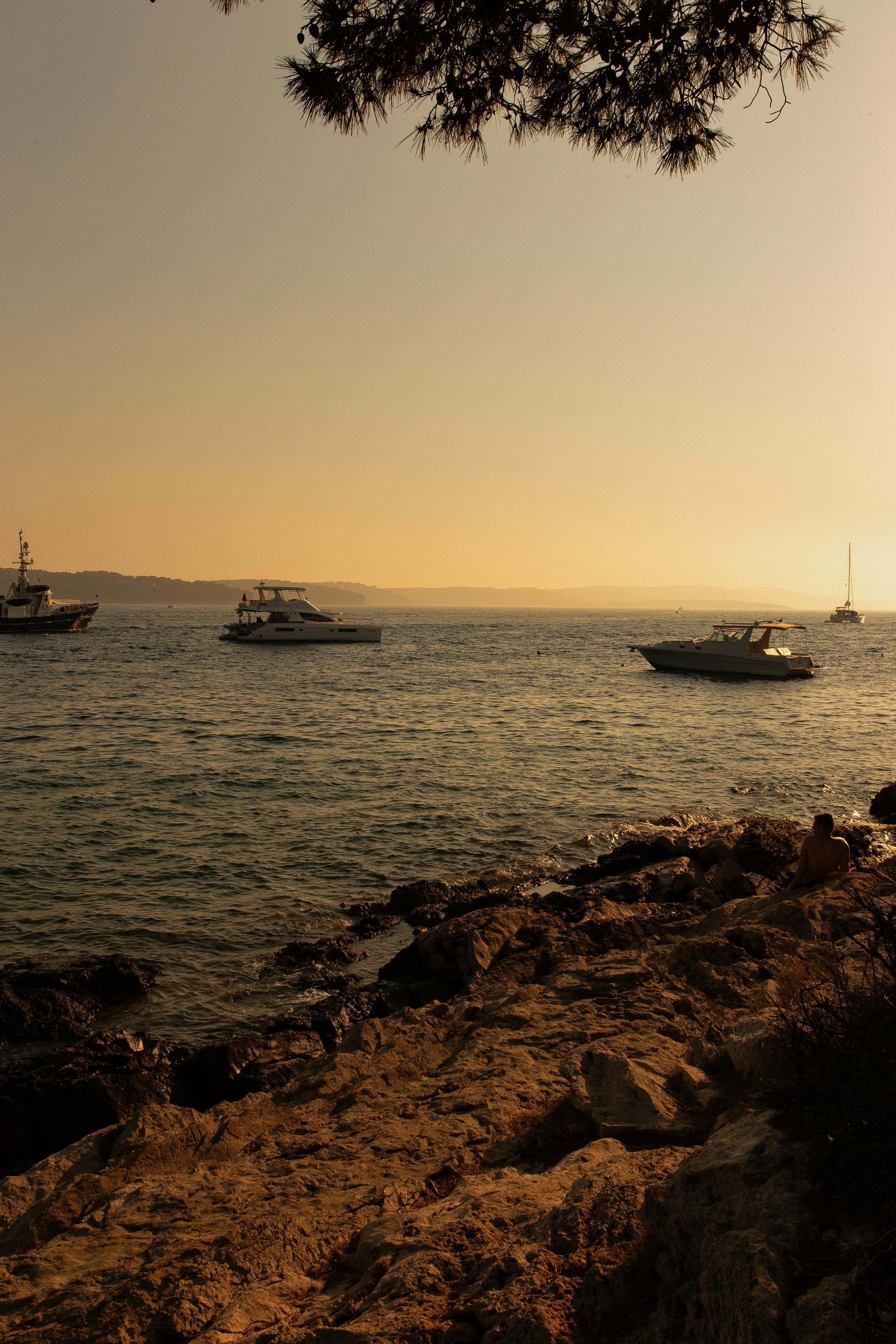 A group of boats floating on top of a body of water