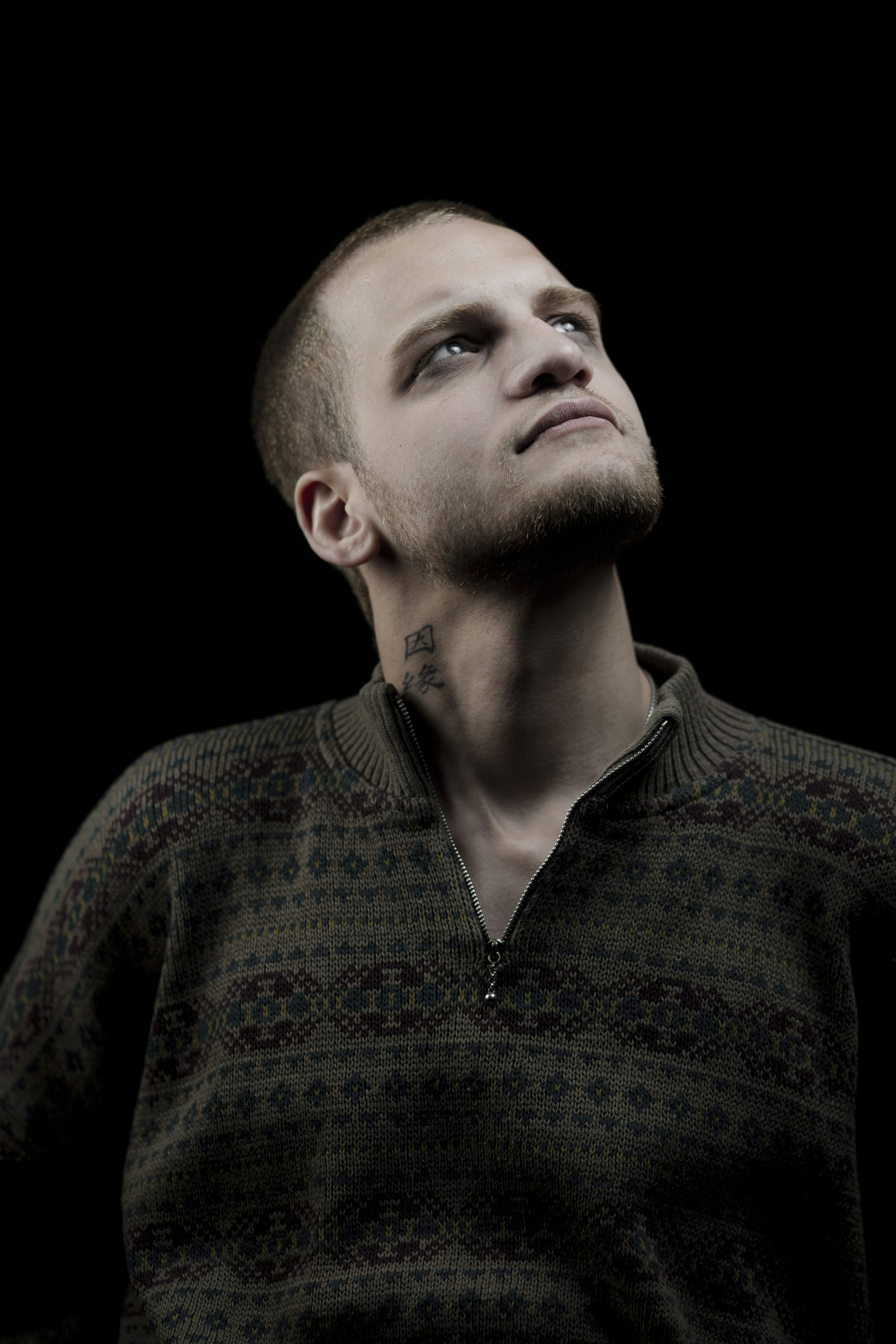 A man with a bald head looking up