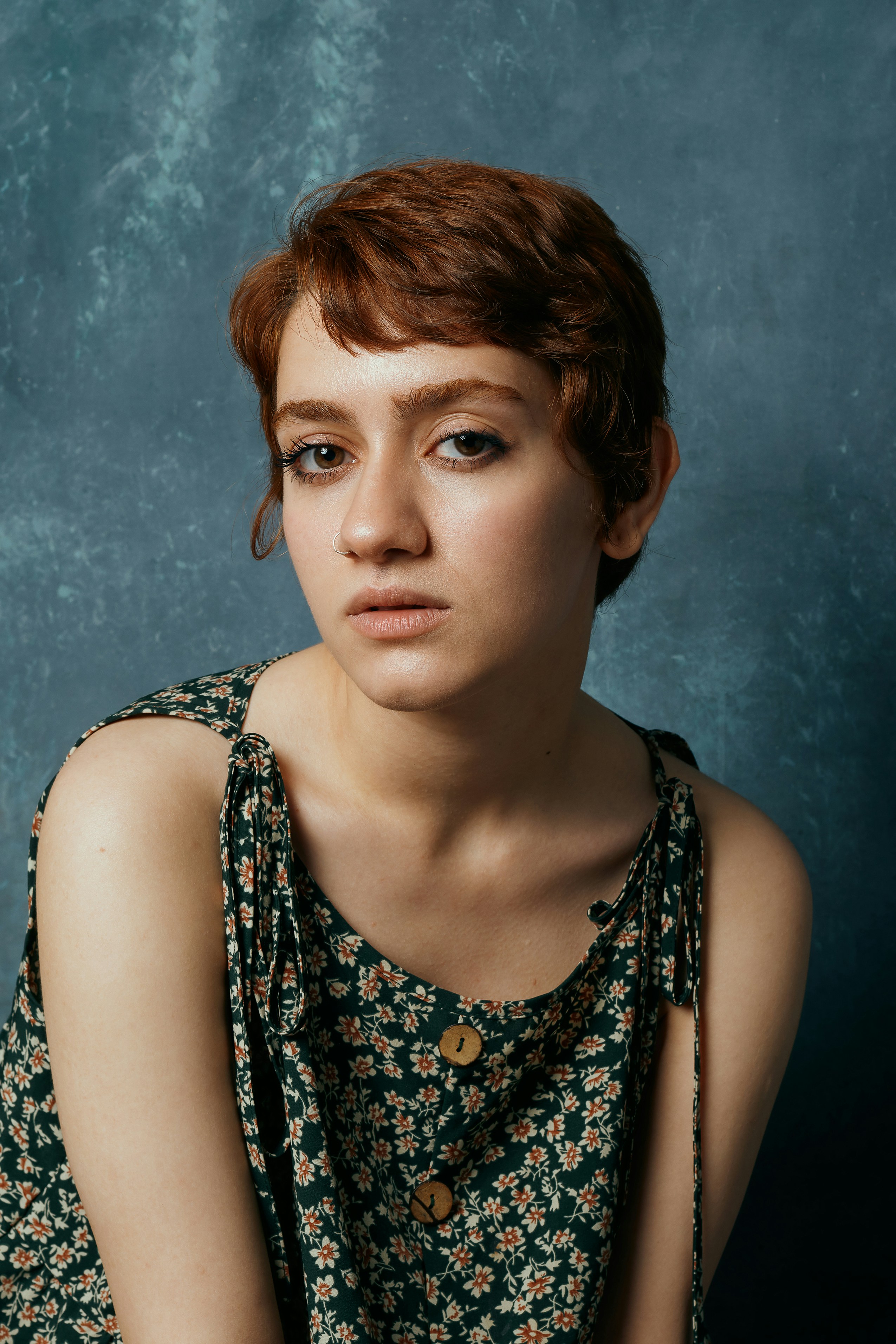 A woman with red hair is sitting down