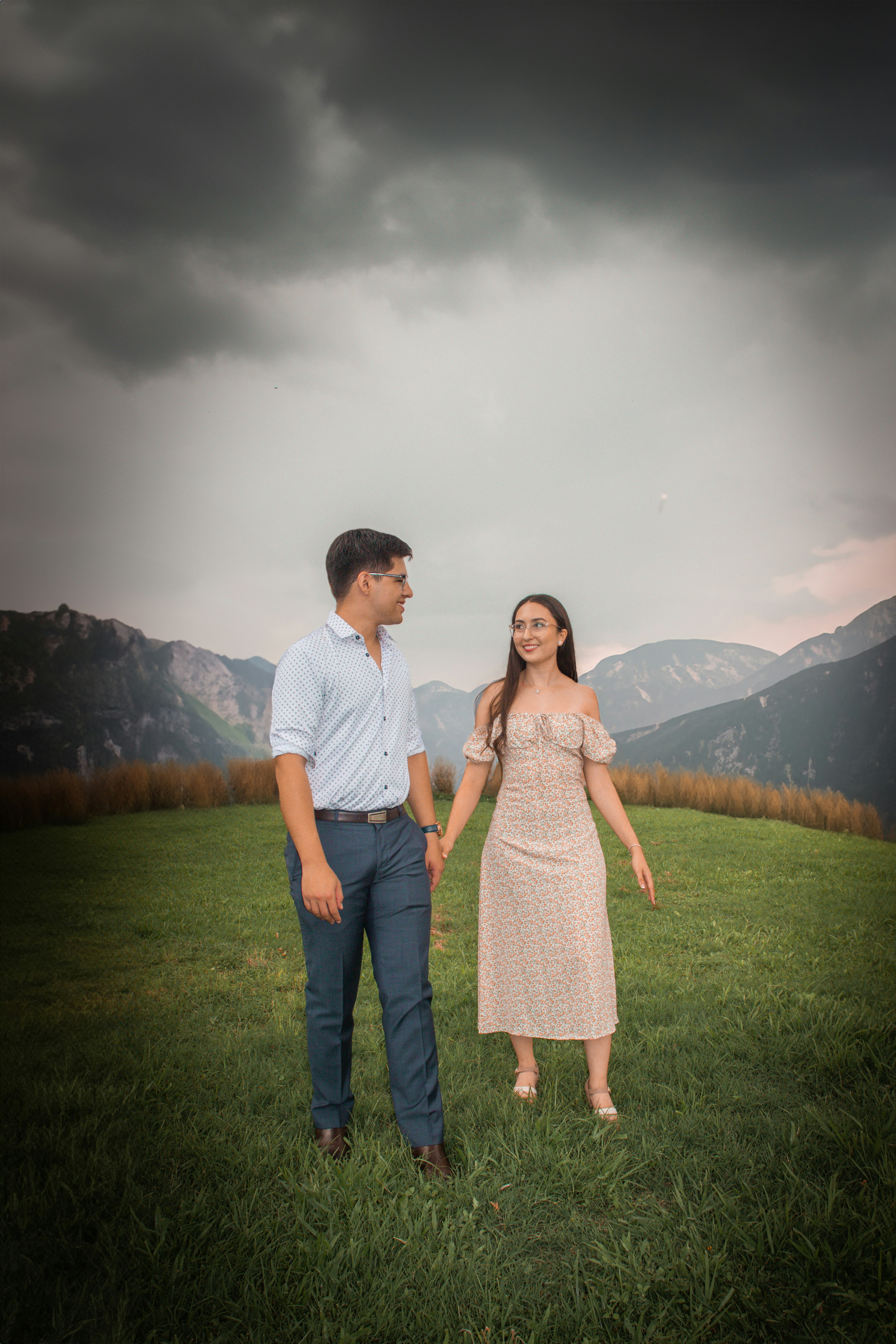 A man and a woman standing in a field