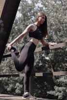 A woman in a black sports bra top and leggings