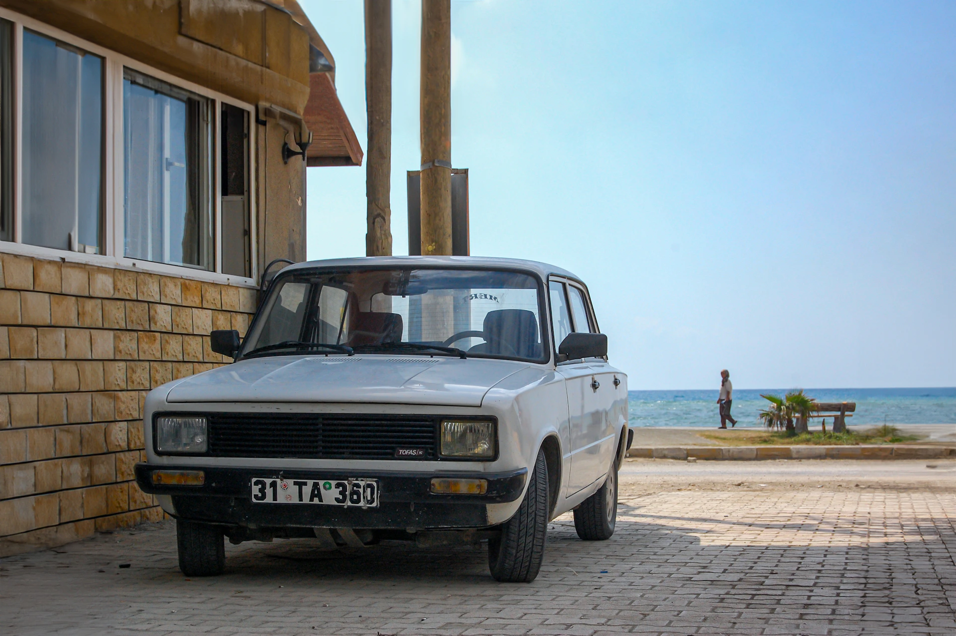A white car parked in front of a building