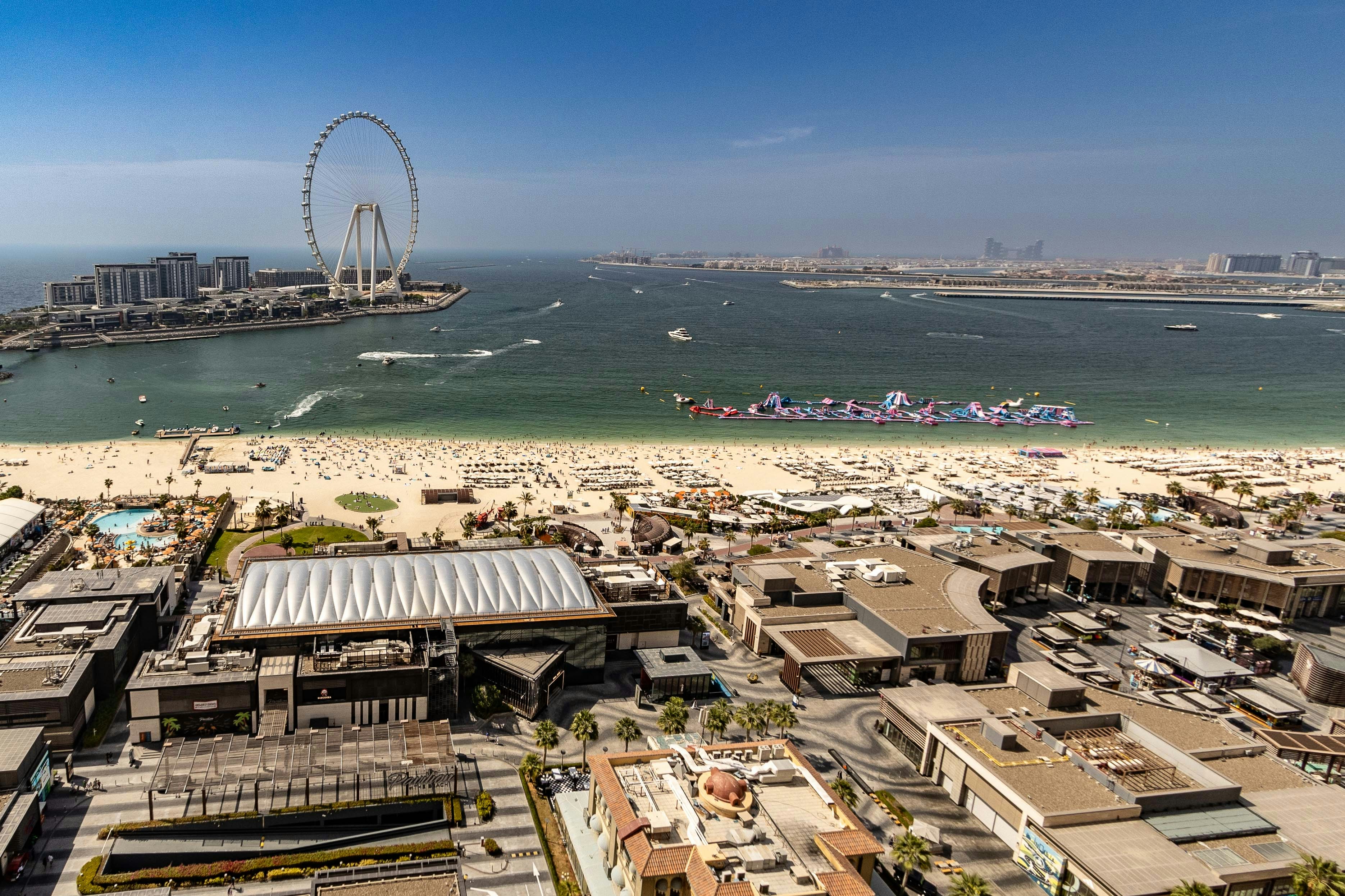 An aerial view of a city with a ferris wheel in the background
