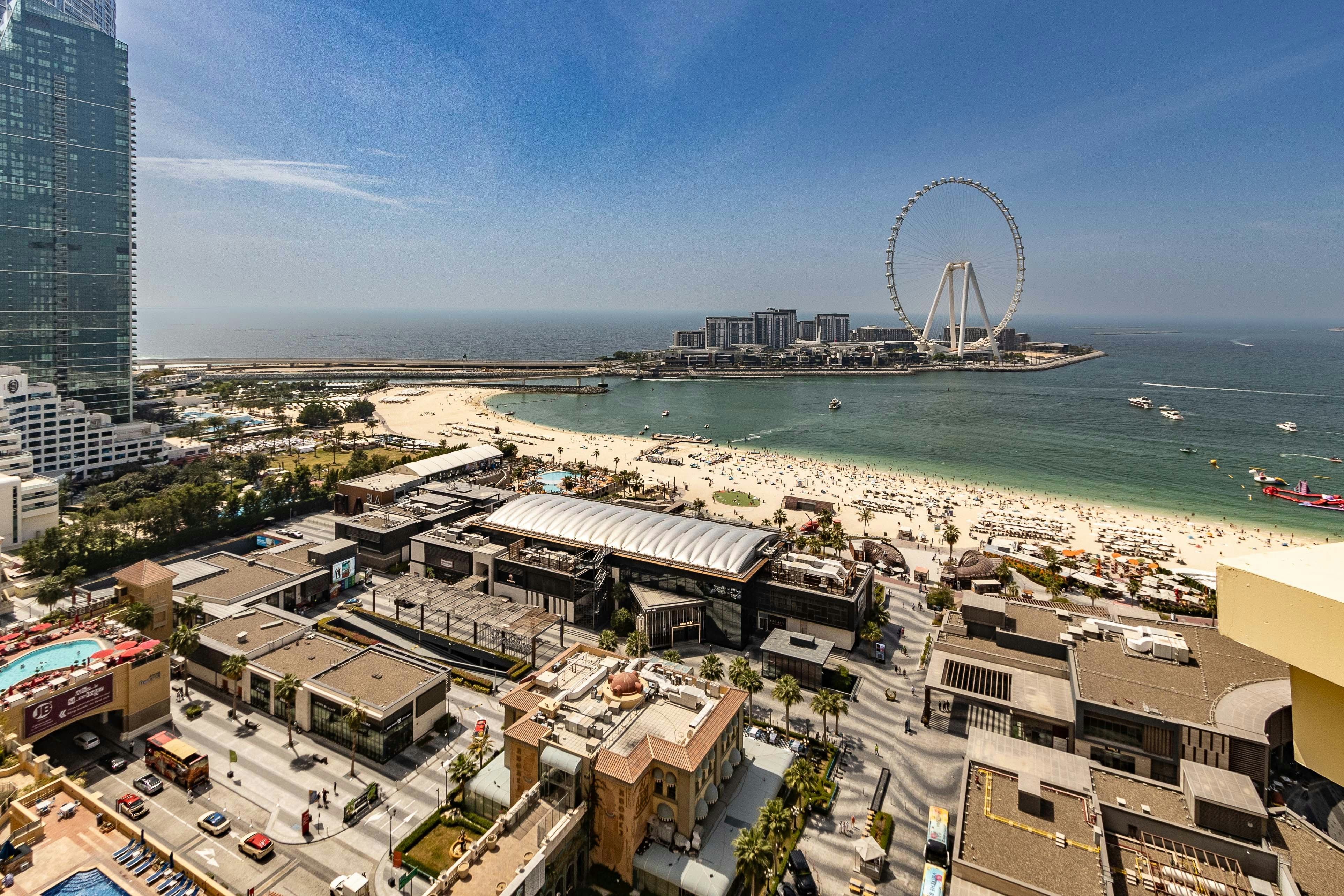 An aerial view of a city with a ferris wheel in the background