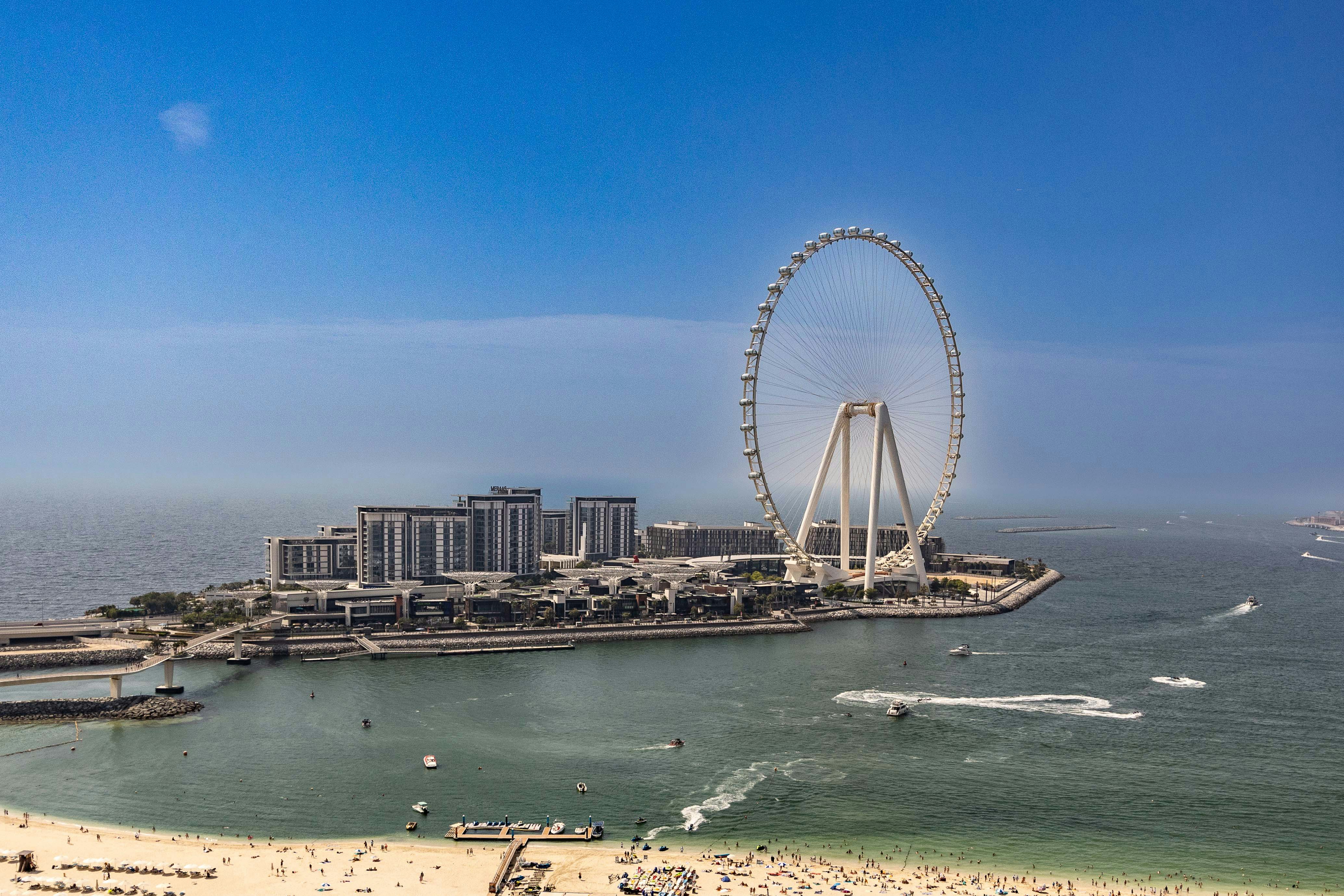 An aerial view of a beach with a ferris wheel