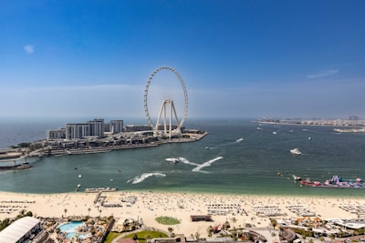 An aerial view of a beach with a ferris wheel