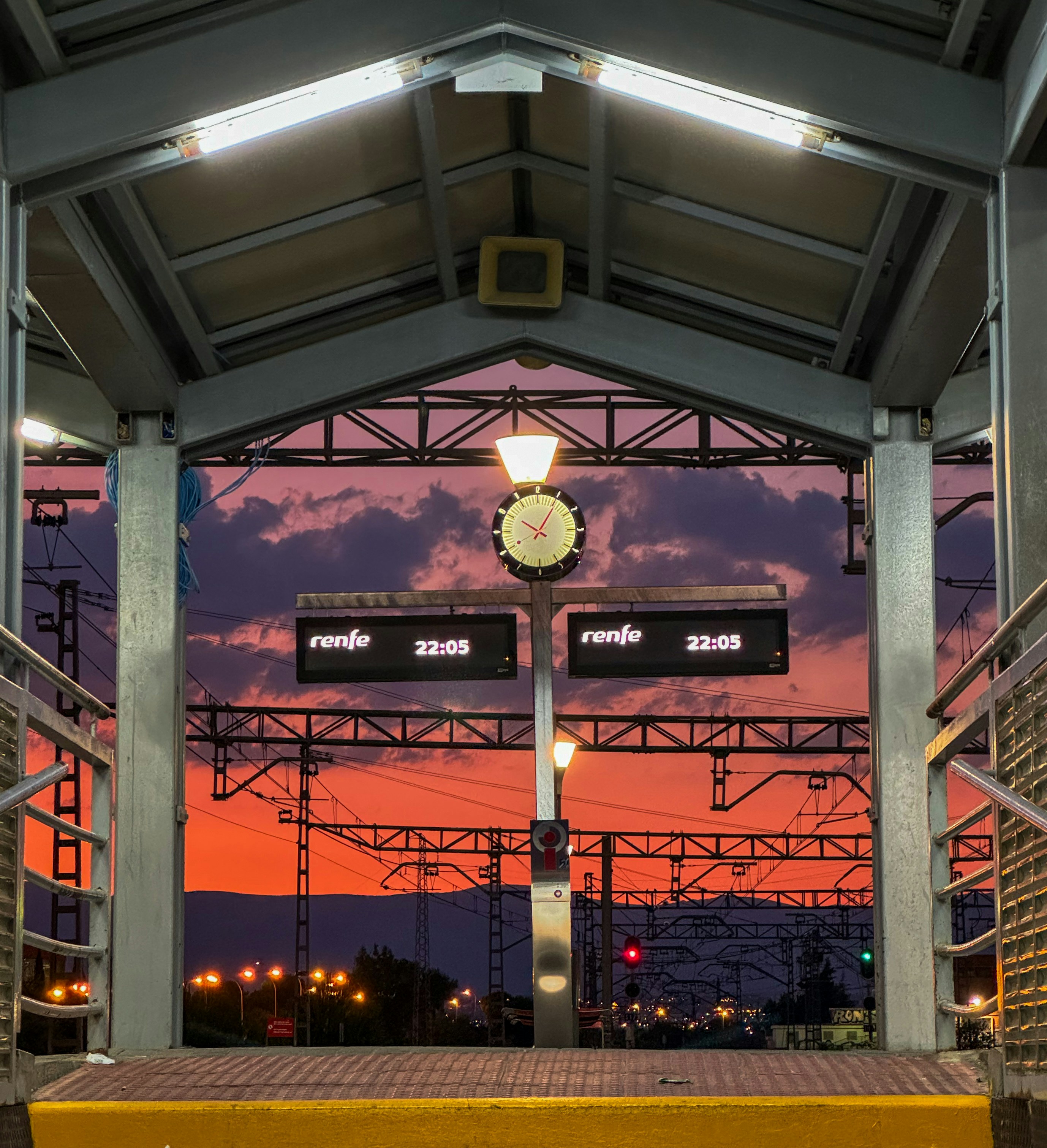 A train station with a clock on the front of it
