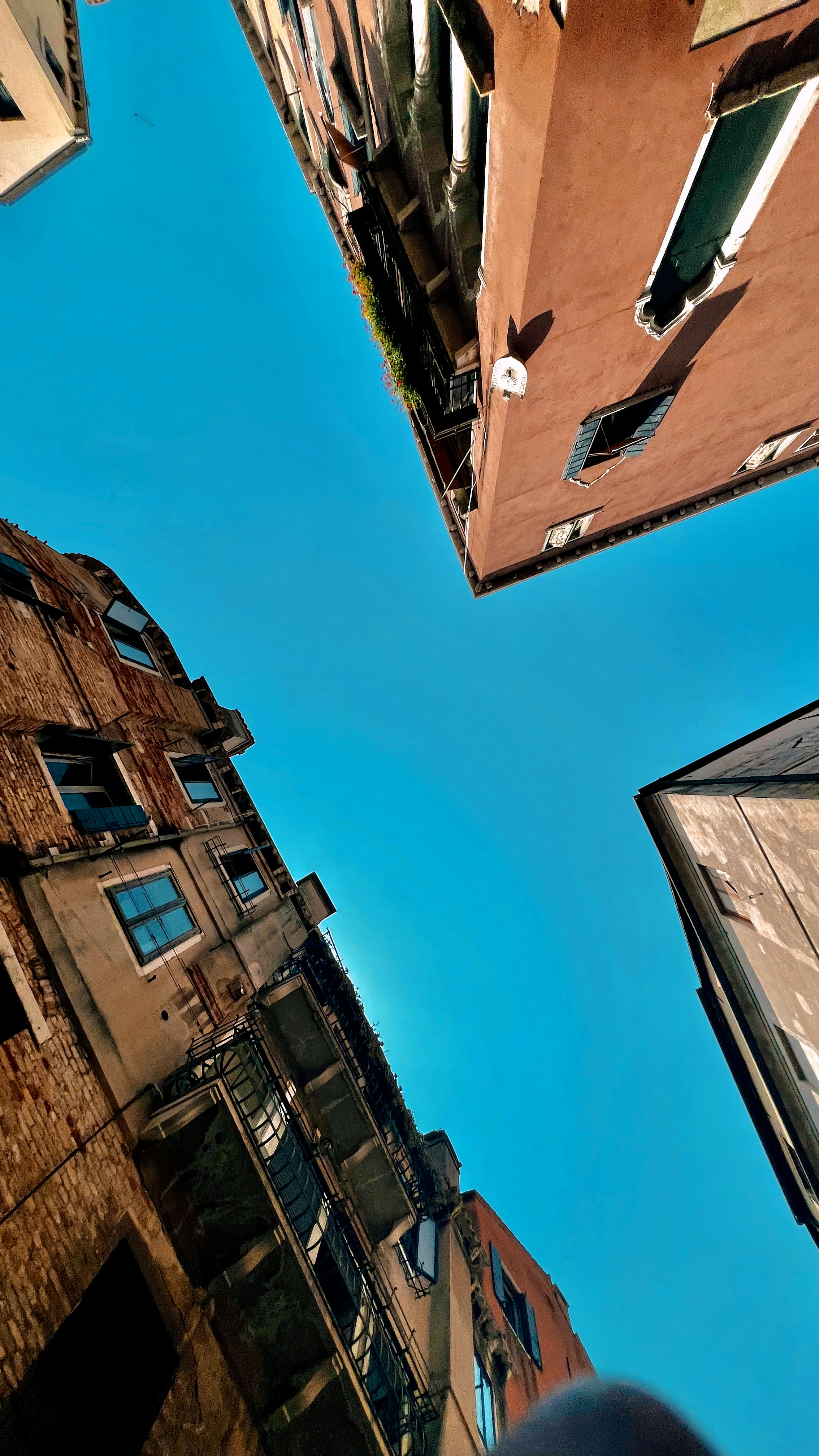 Looking up at a tall building with a blue sky in the background
