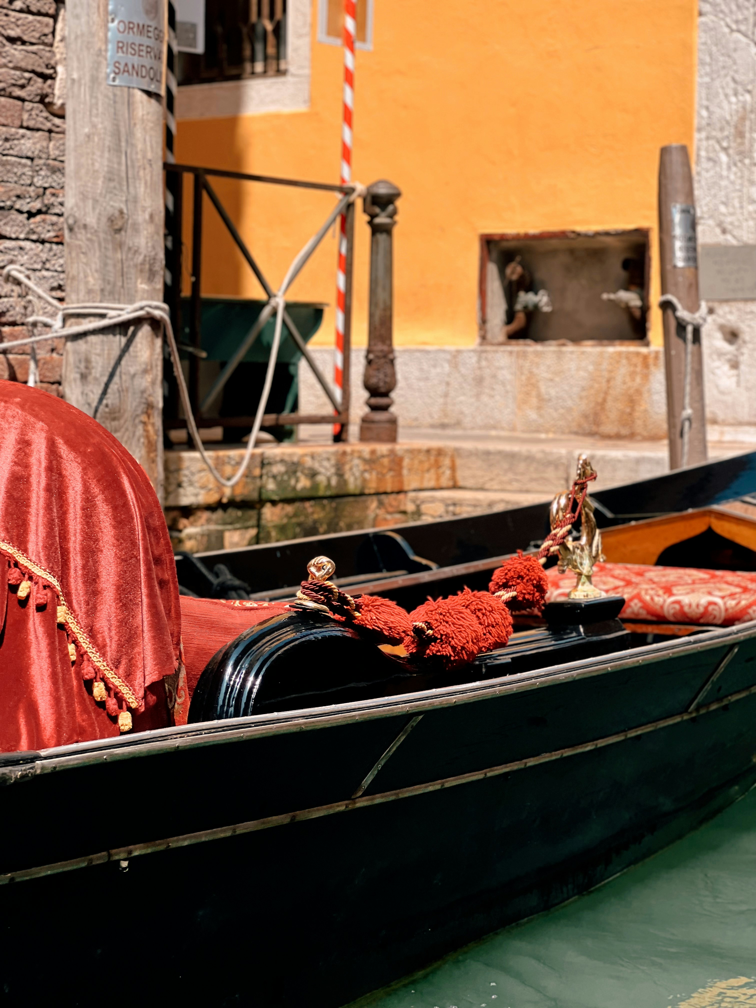 A gondola with a red cloth on the front of it