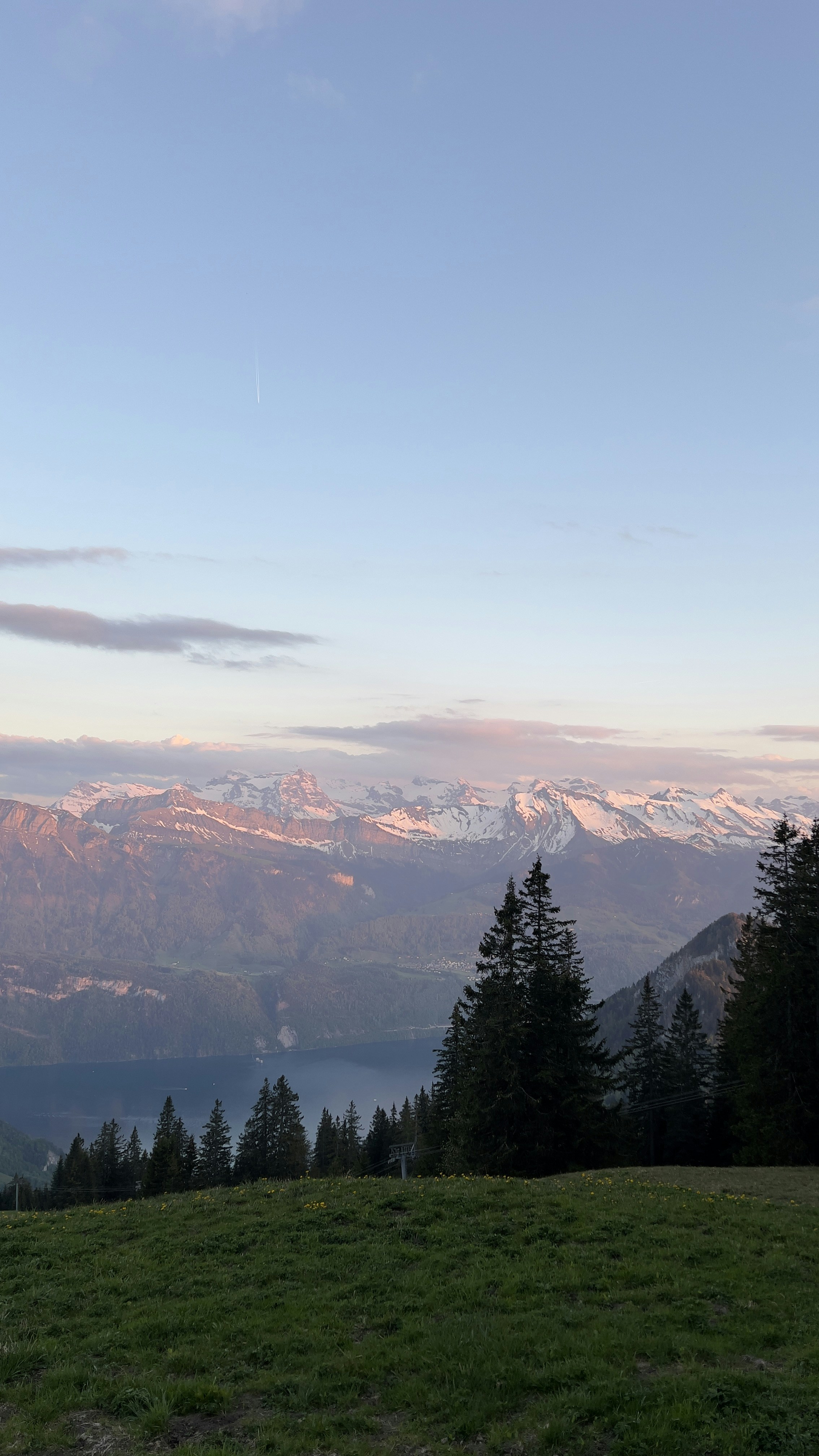 A view of a mountain range with trees and mountains in the background