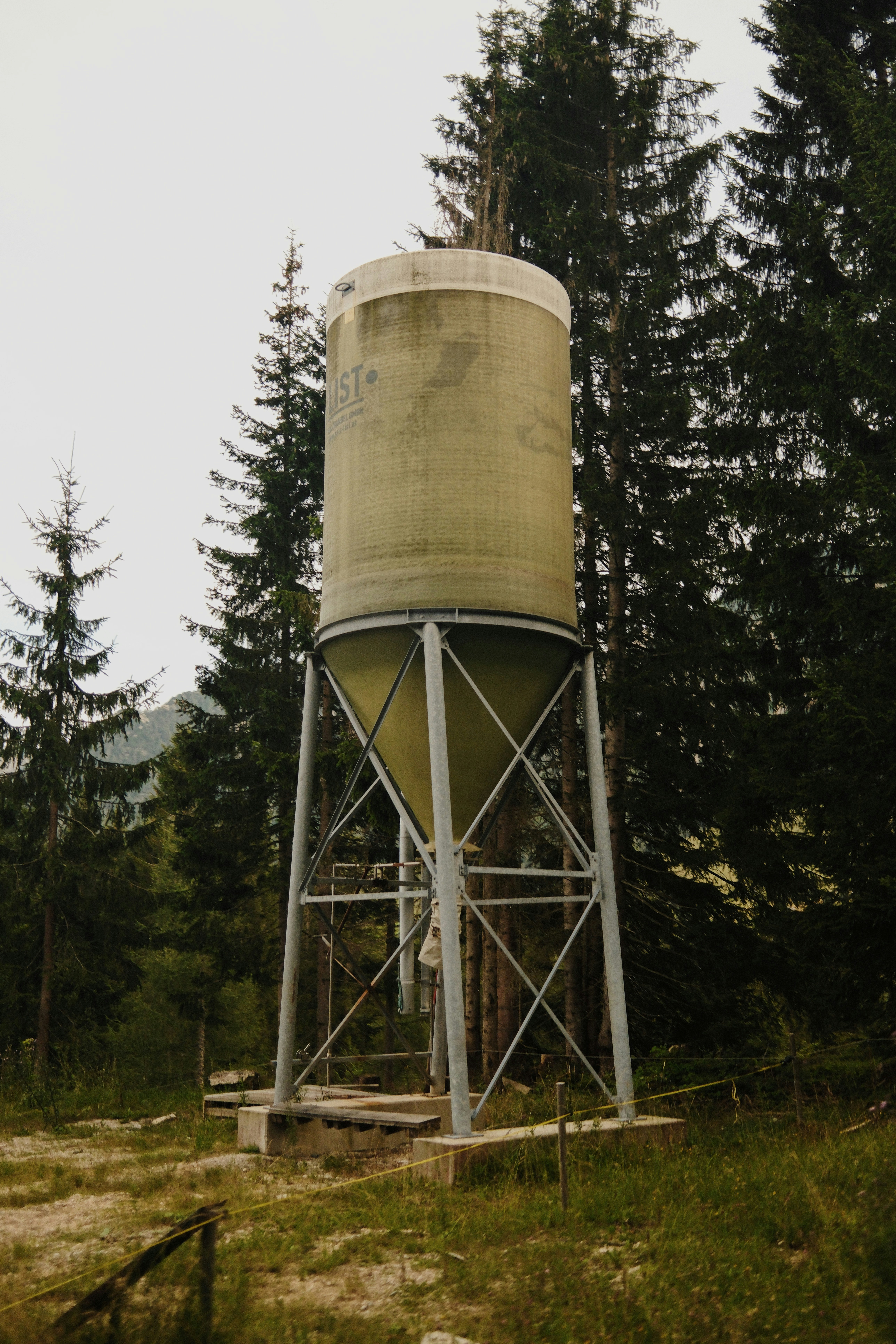 A water tower in the middle of a forest