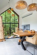 A dining room with a wooden table and chairs