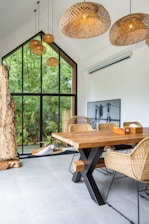 A dining room with a wooden table and chairs