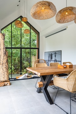A dining room with a wooden table and chairs