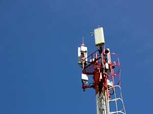 A cell phone tower with a blue sky in the background