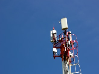 A cell phone tower with a blue sky in the background