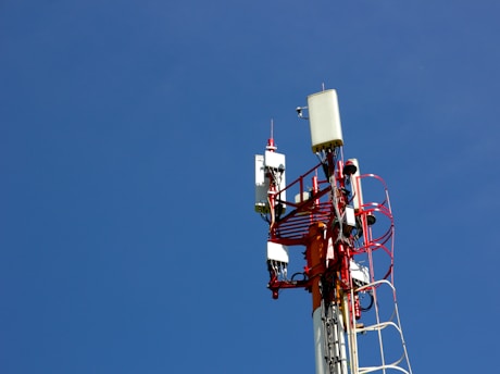 A cell phone tower with a blue sky in the background