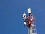 A cell phone tower with a blue sky in the background