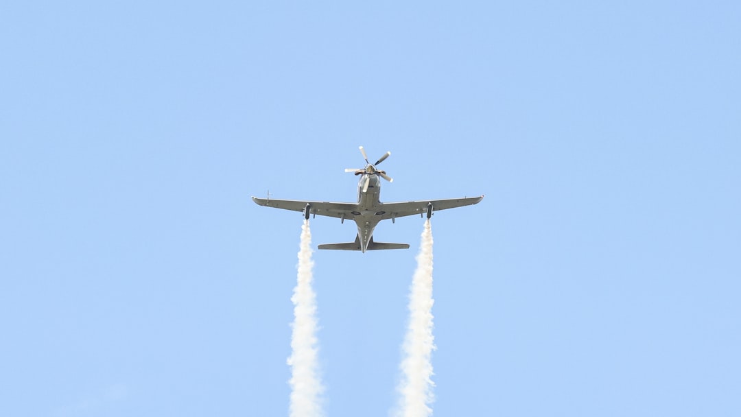 A plane flying in the air with two smoke trails behind it, Hürkuş in demonstration flight.