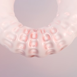 A close up of a plastic object on a white background