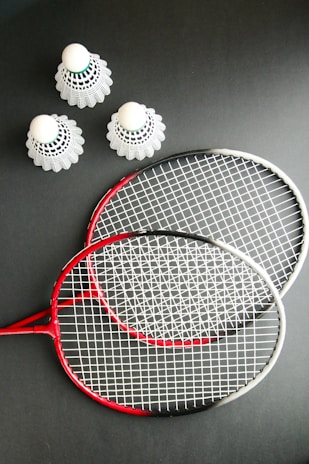 A couple of tennis rackets sitting on top of a table