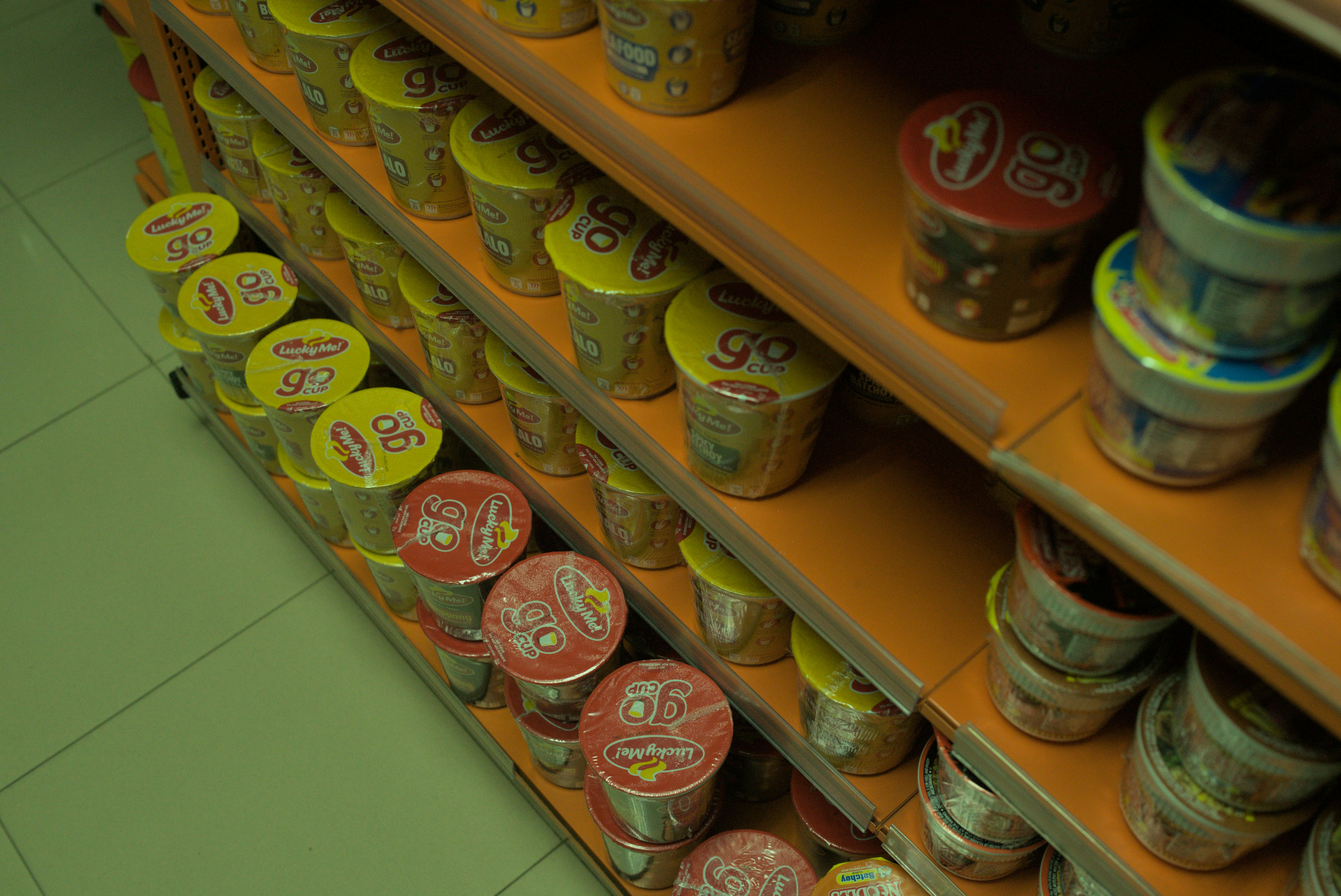 A store shelf filled with lots of coffee cups