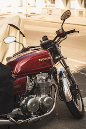 A red motorcycle parked on the side of the road