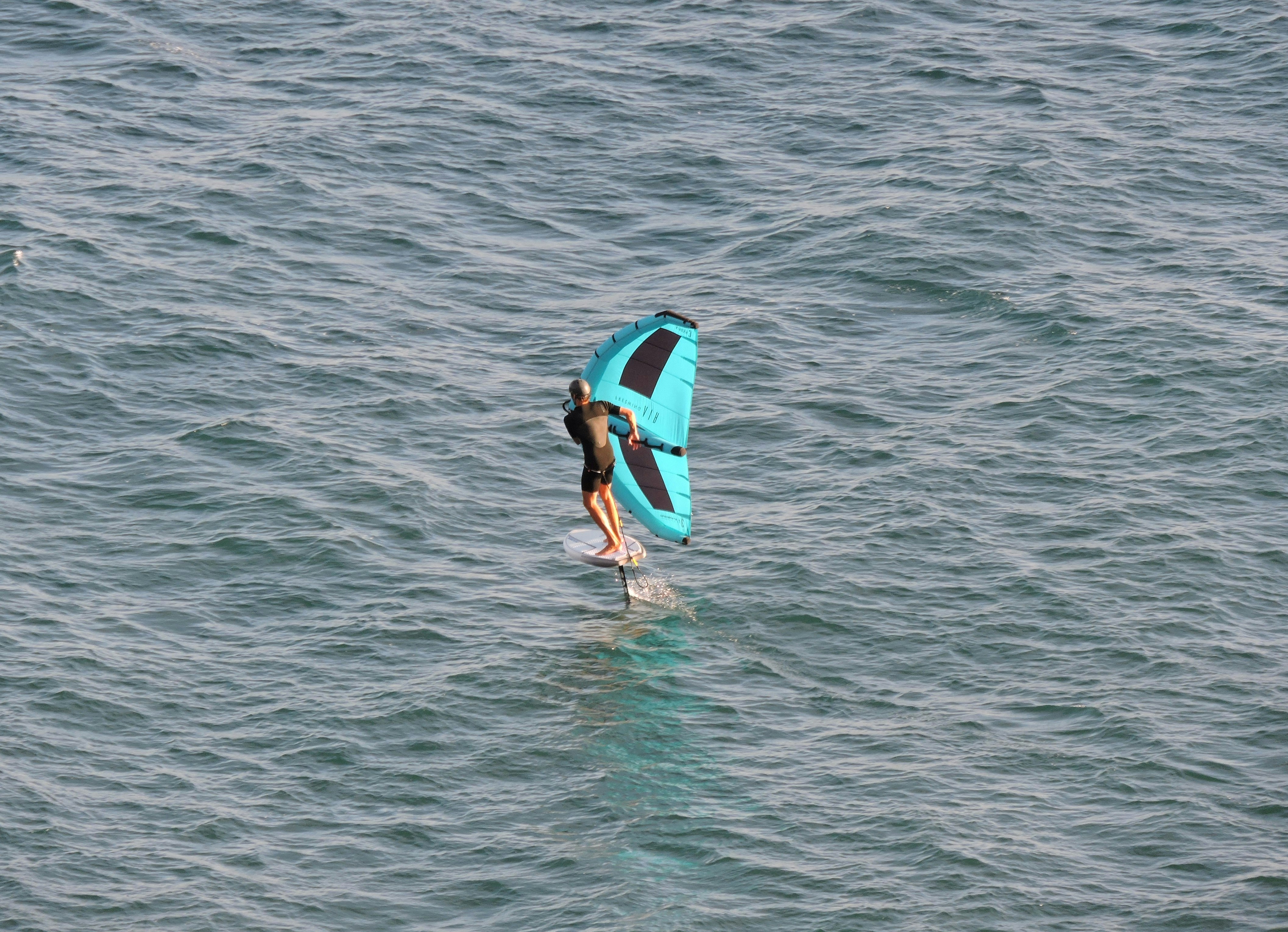 A man riding a surfboard on top of a body of water