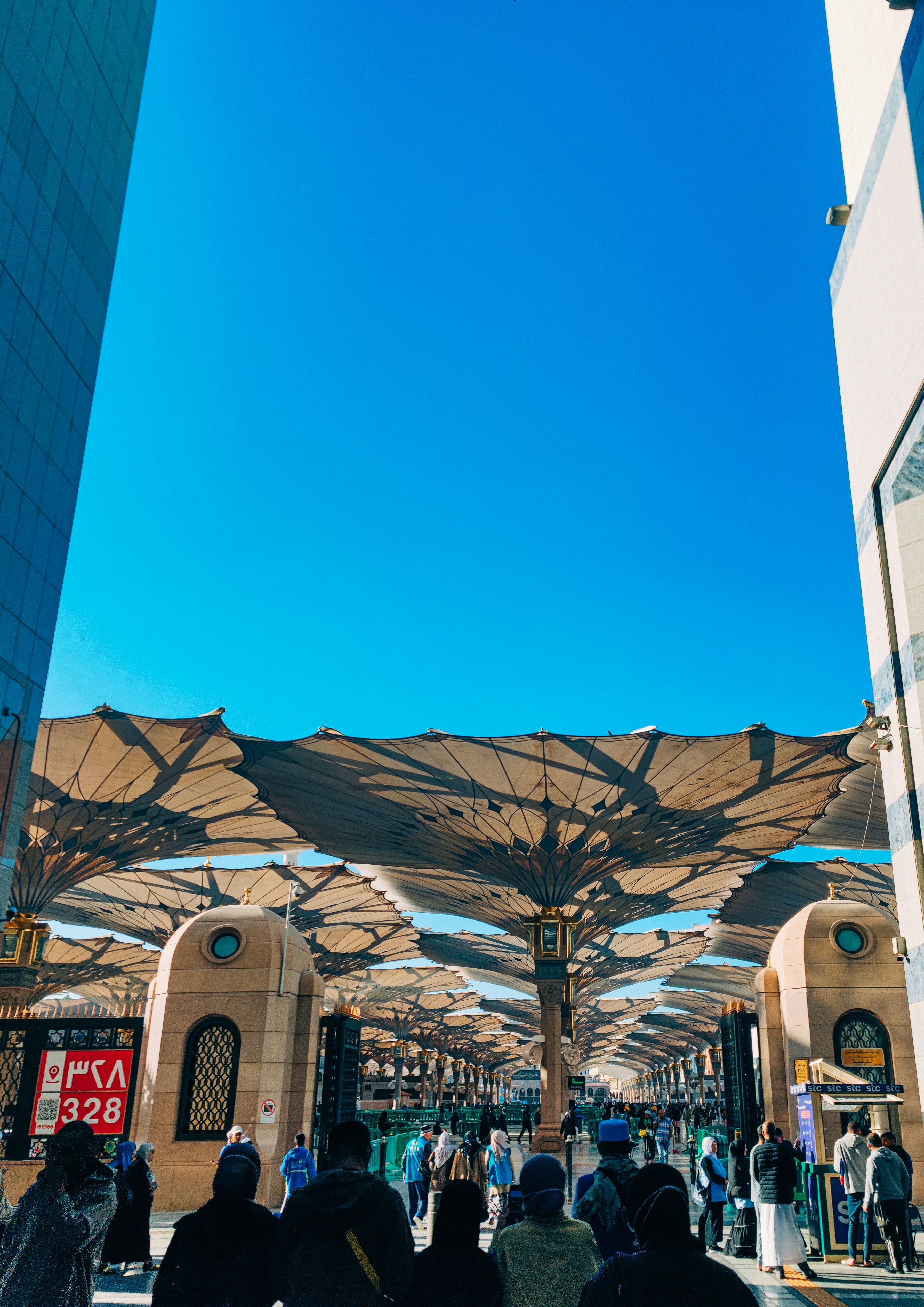 A group of people walking through a covered walkway