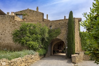 A stone building with a tree in front of it
