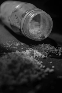 A bottle filled with sugar sitting on top of a table