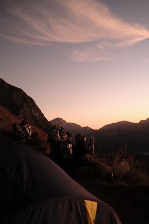 A group of people sitting on top of a mountain