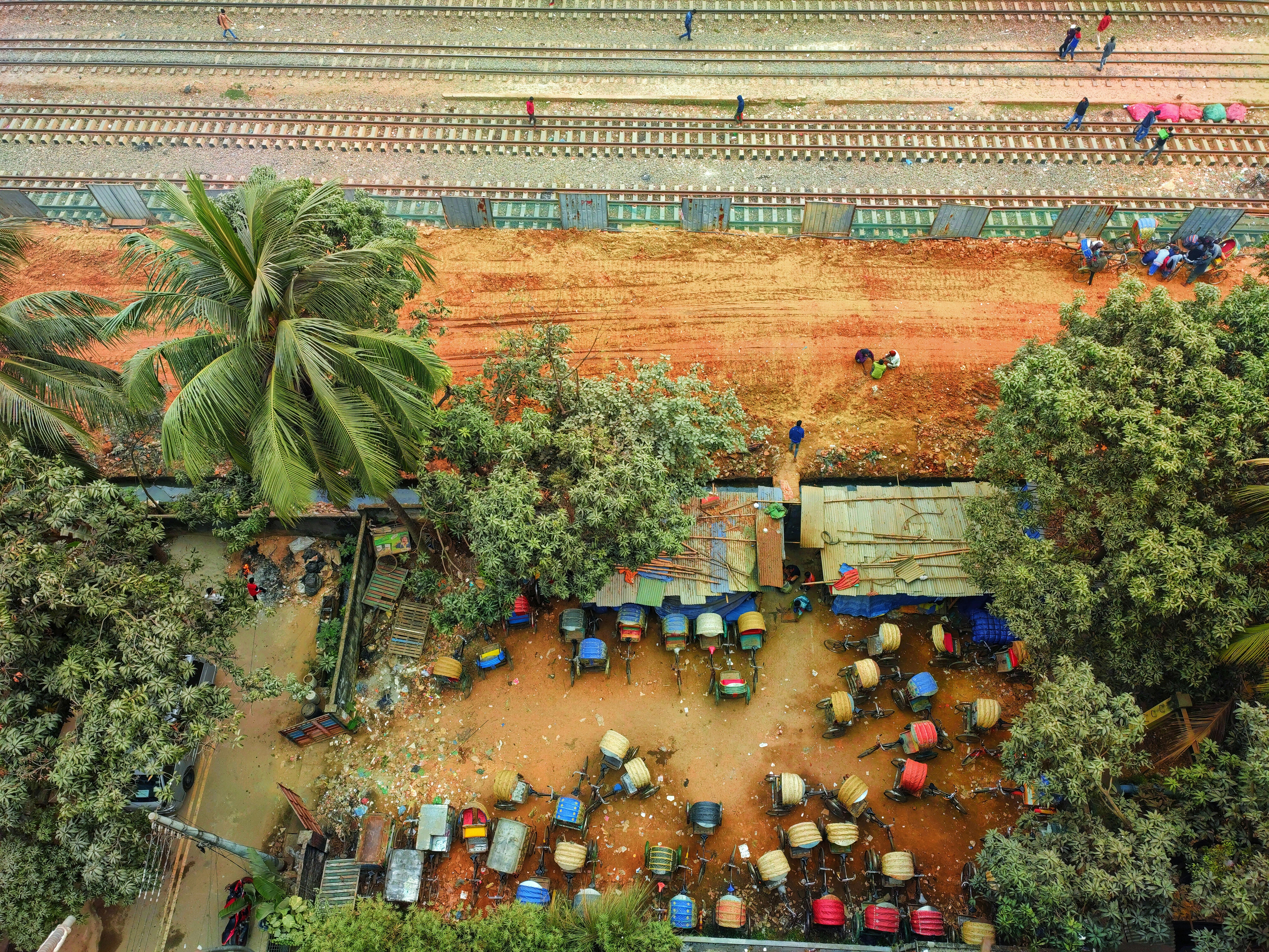 An aerial view of a train yard with people walking around