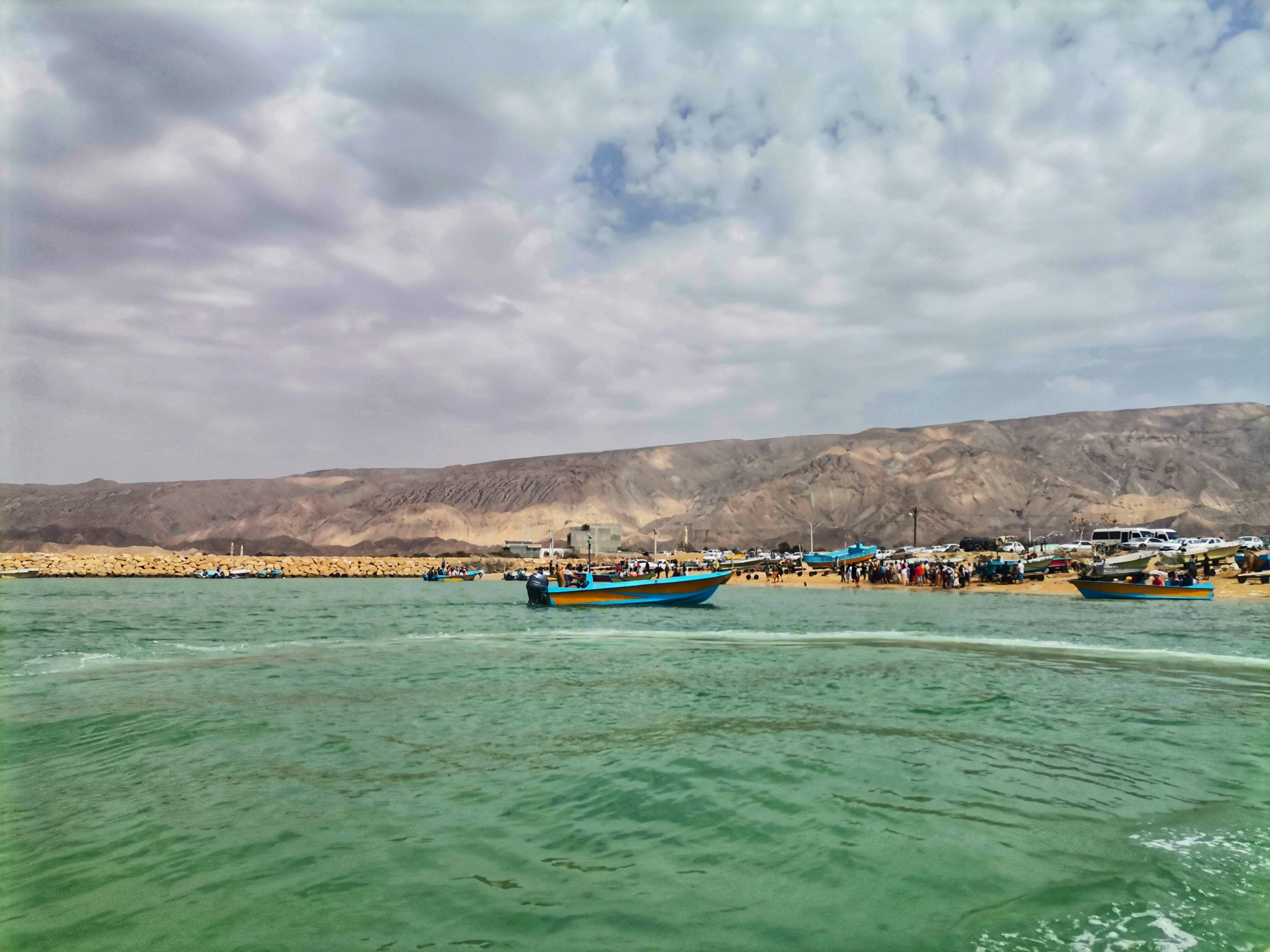A body of water with boats in the distance