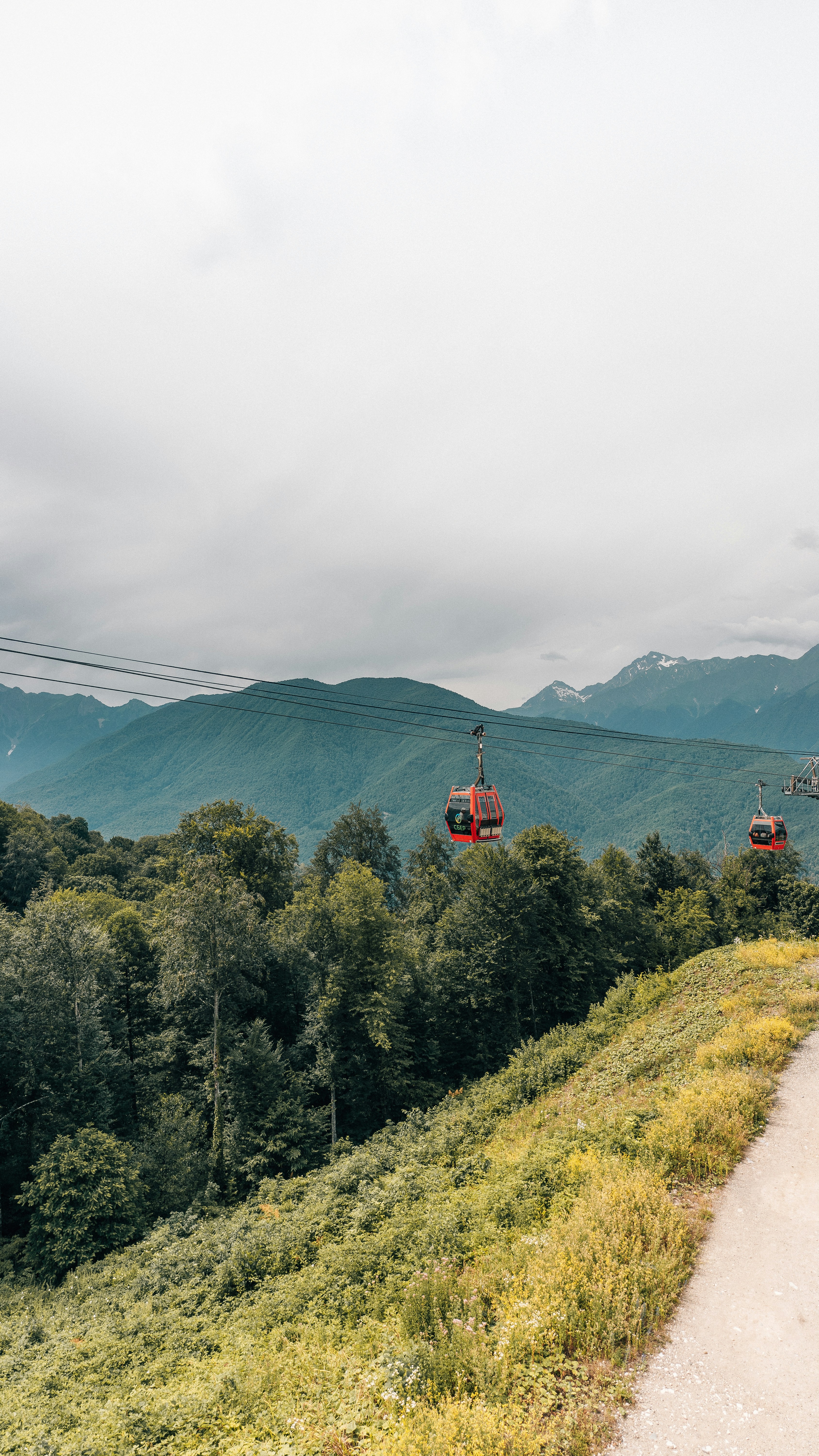 A scenic view of a mountain with a cable car in the distance
