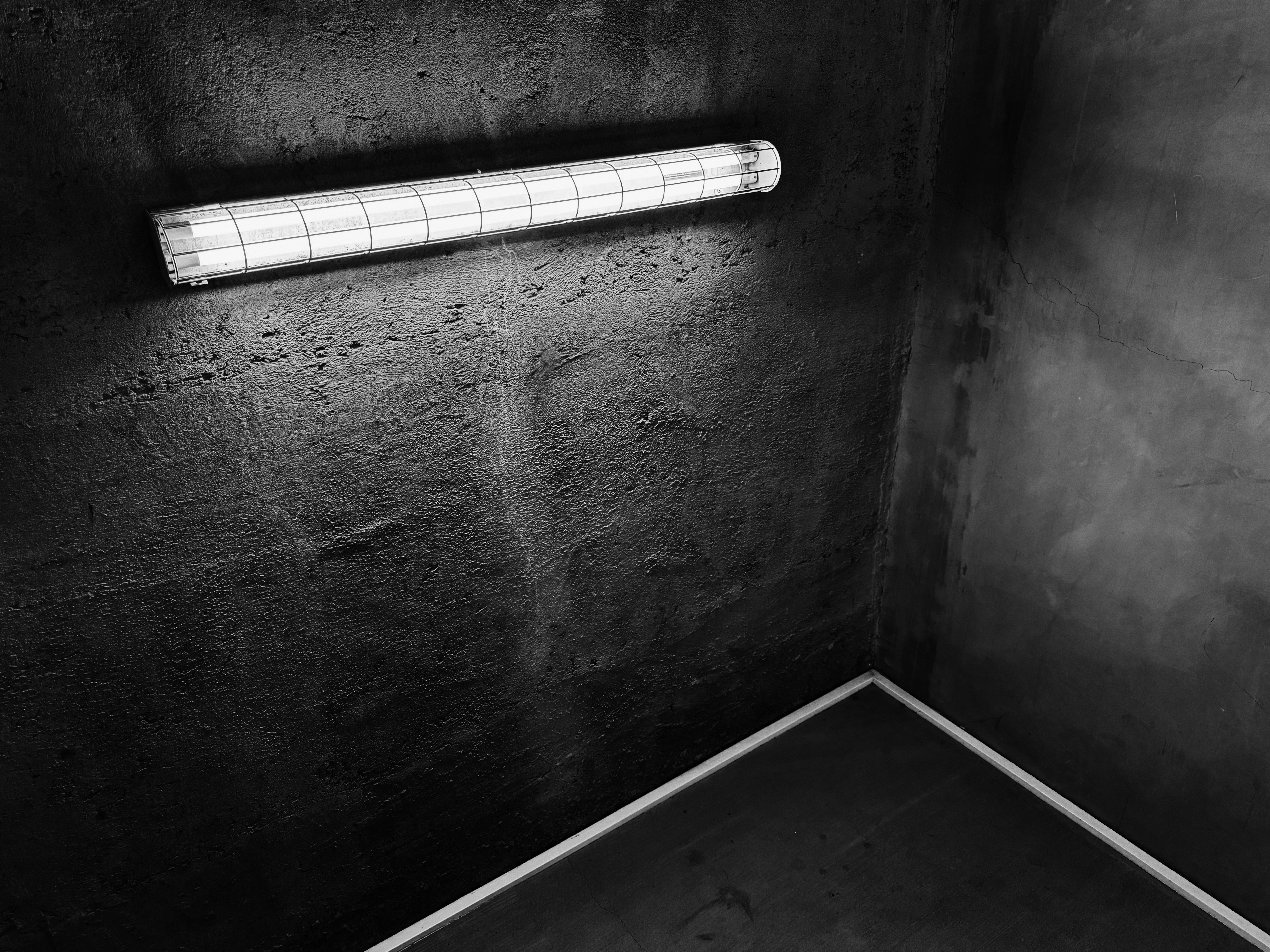 A black and white photo of a corner of a room