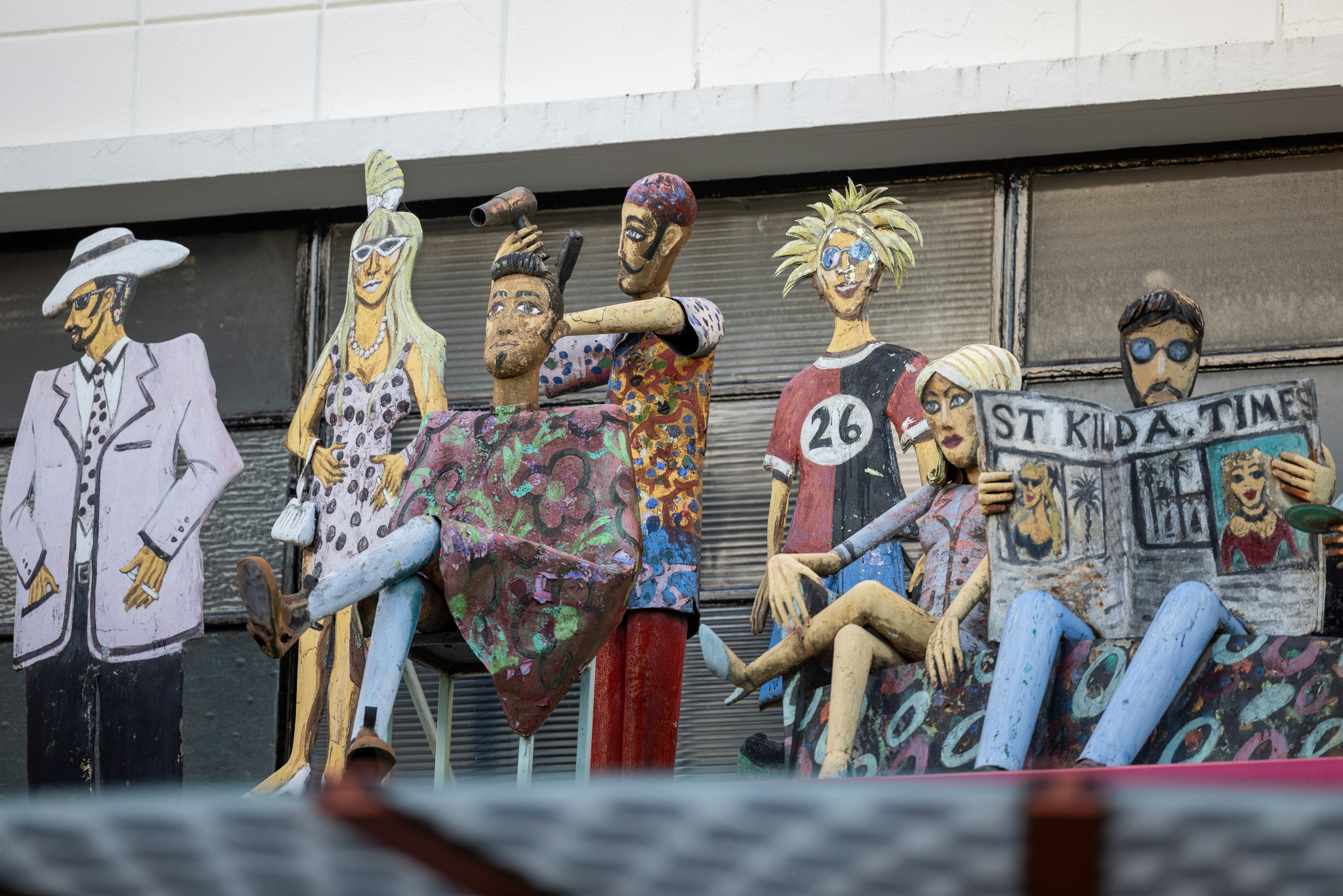 A group of statues of people sitting on top of each other photo – Free ...