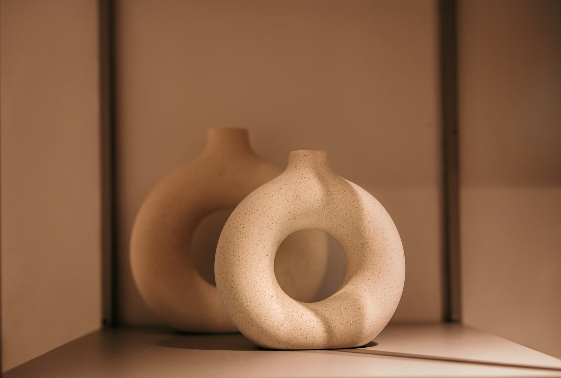 A white vase sitting on top of a shelf