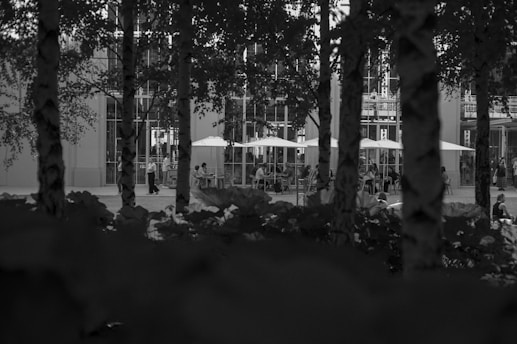 A black and white photo of a building and trees